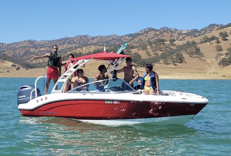 Group of people in ski boat getting ready to pull a wakeboarder.