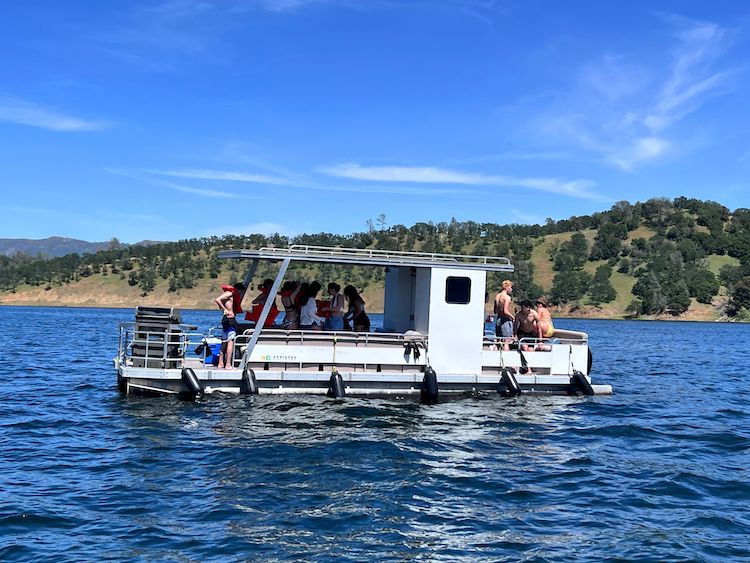 Group on large ponton boat in the lake.